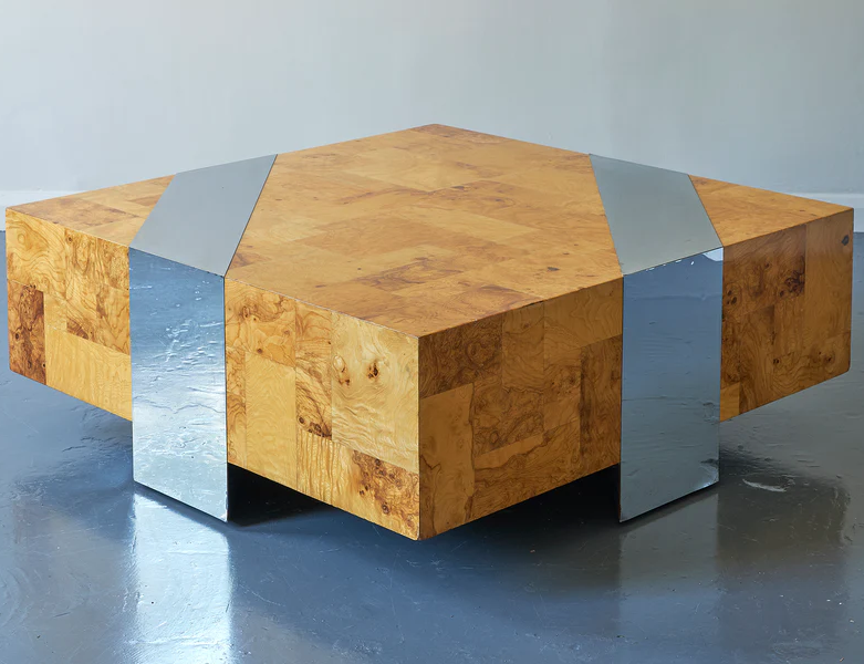 A Brutalist coffee table by Paul Evans, of his signature patchwork style employed in the 1970s, of square shape, patched burl olive wood with trapezoid inserts of chromed steel.
