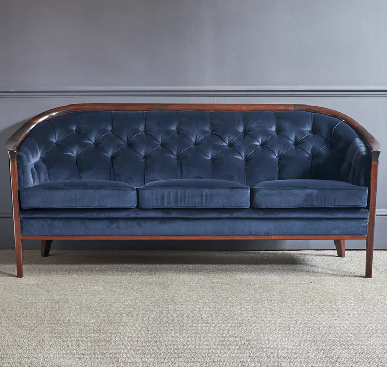 A Swedish 'Aristocrat' club sofa by Bertil Fridhagen, for Bröderna Andersson with buttoned back and of rounded form with sweeping arms
